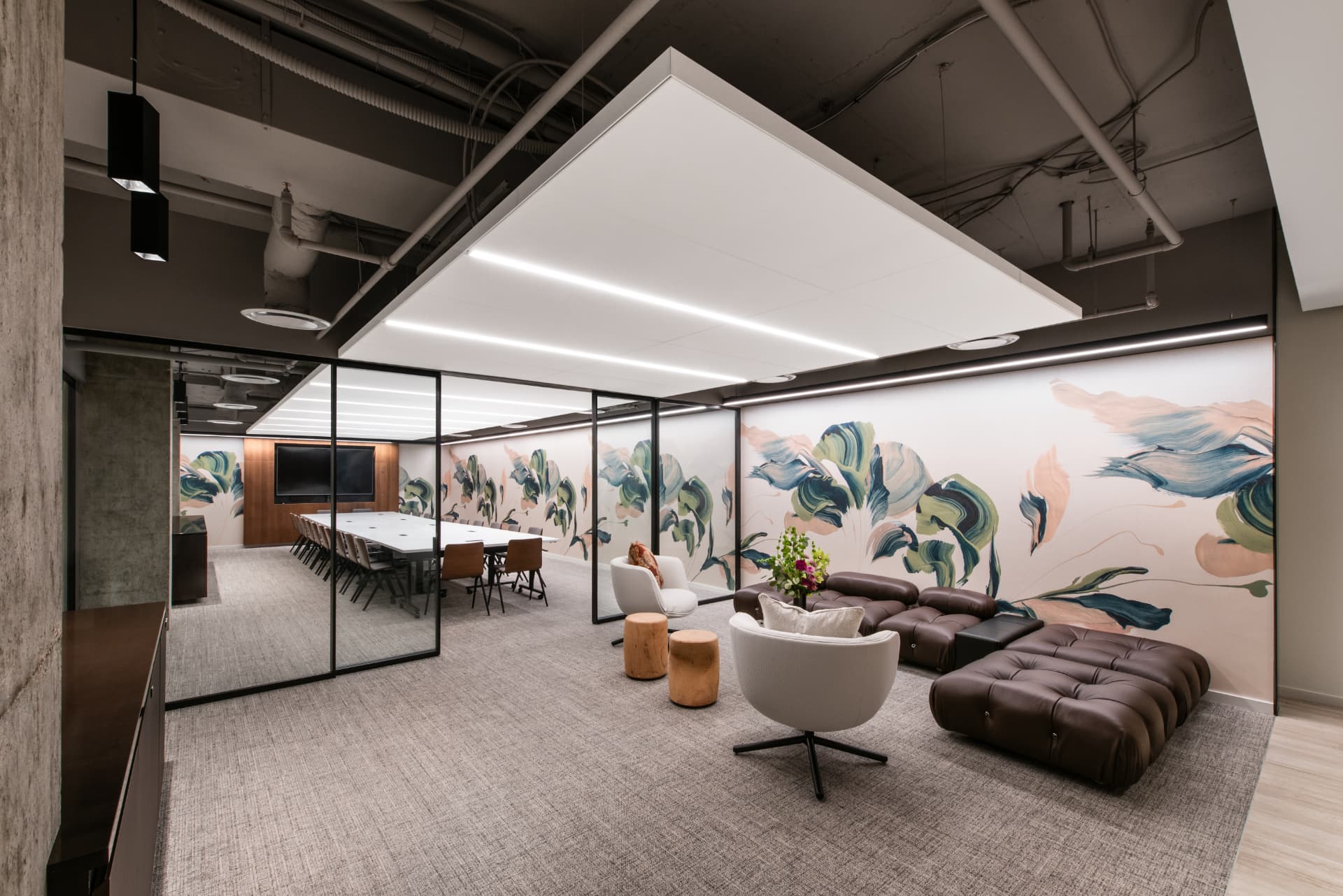 Conference room with lounge seating and botanical mural