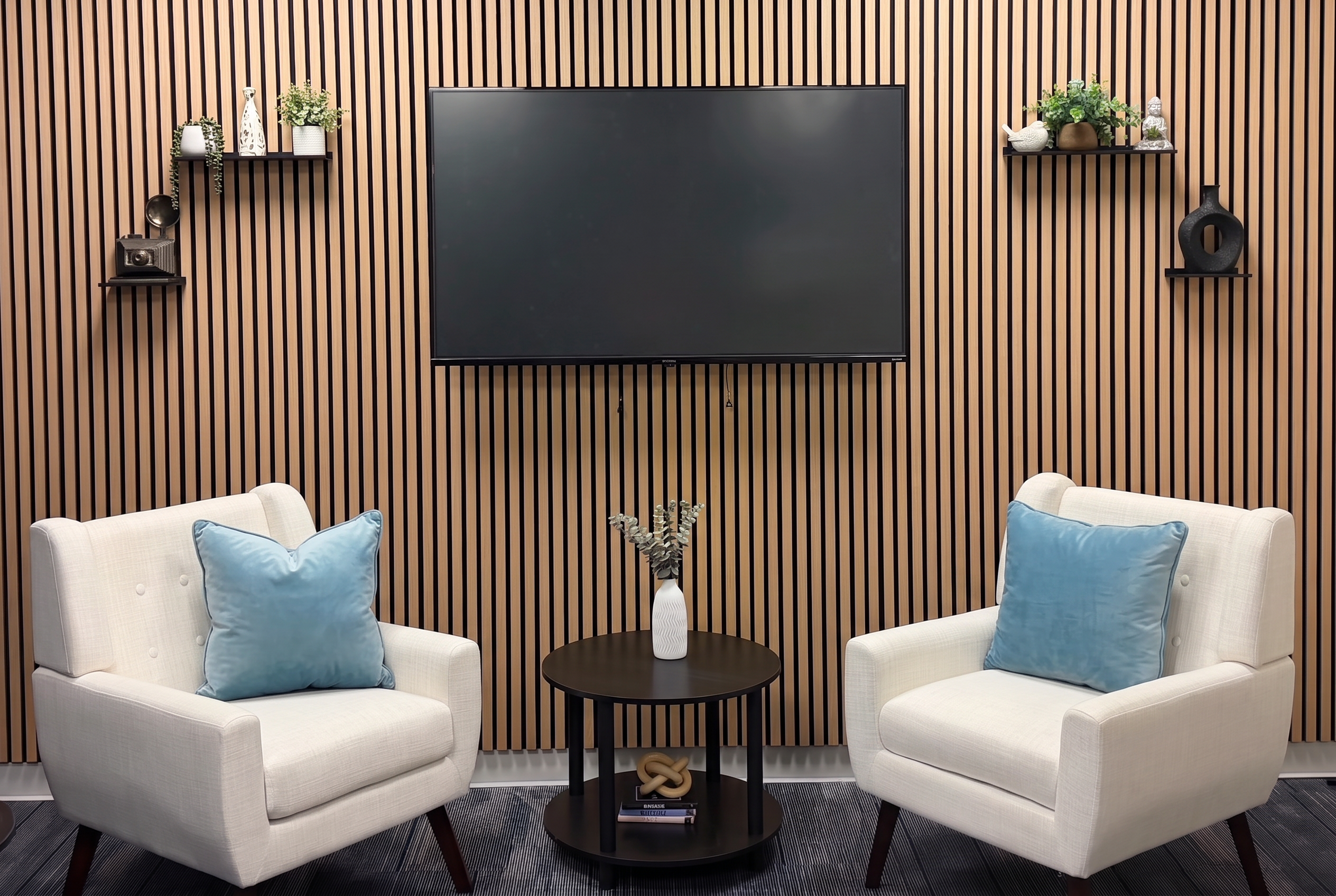Podcast studio with slatted wood wall and armchairs